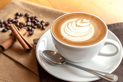 Cup of cafe' latte with coffee beans and cinnamon sticks BEST-ESPRESSO CAPPUCCINO